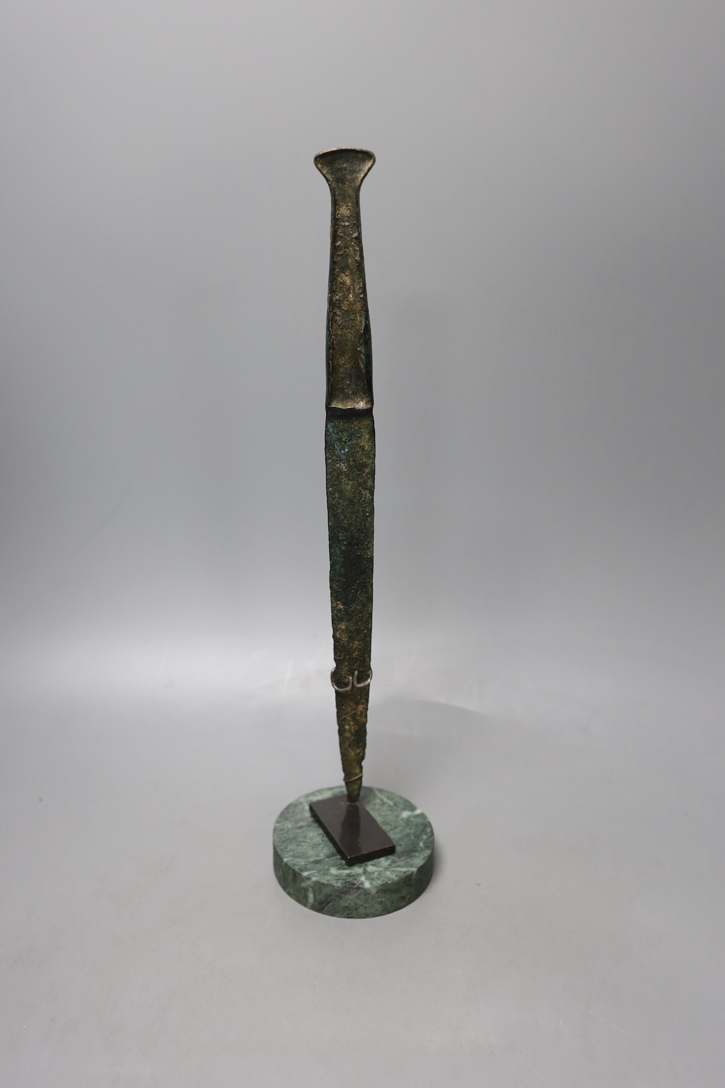 A Lurestan bronze dagger, on stand, 34.5 cms high.